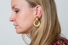 Load image into Gallery viewer, A pair of gold and diamond earclips by Gay Freres.
